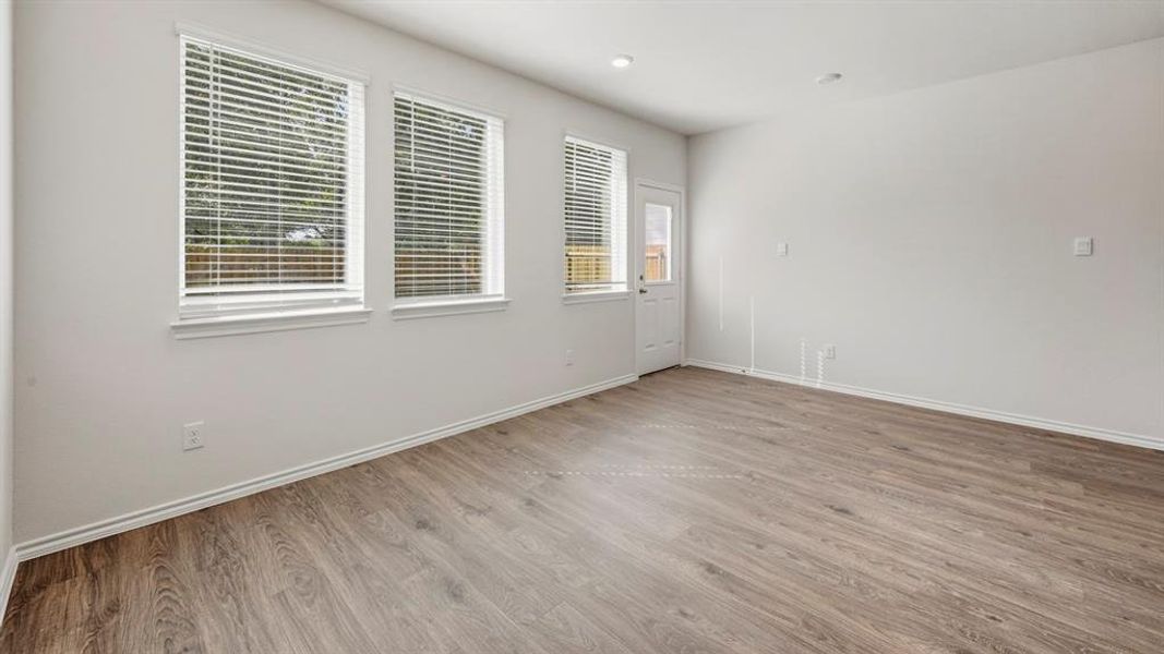 Empty room featuring light wood-style floors and recessed lighting