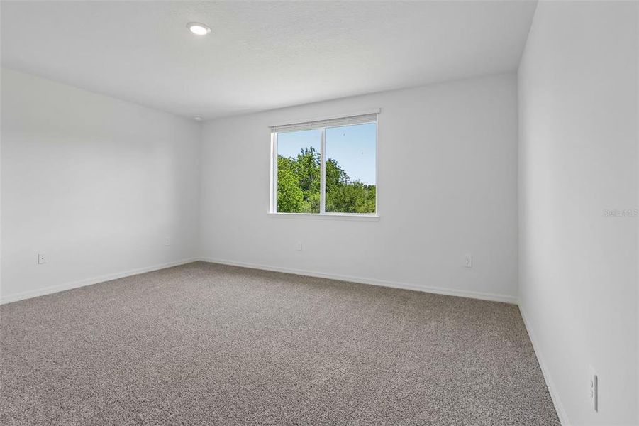 Spacious, unfurnished interior of a new home in The Grove at Stuart Crossing - Signature Series, Bartow (Image 32).