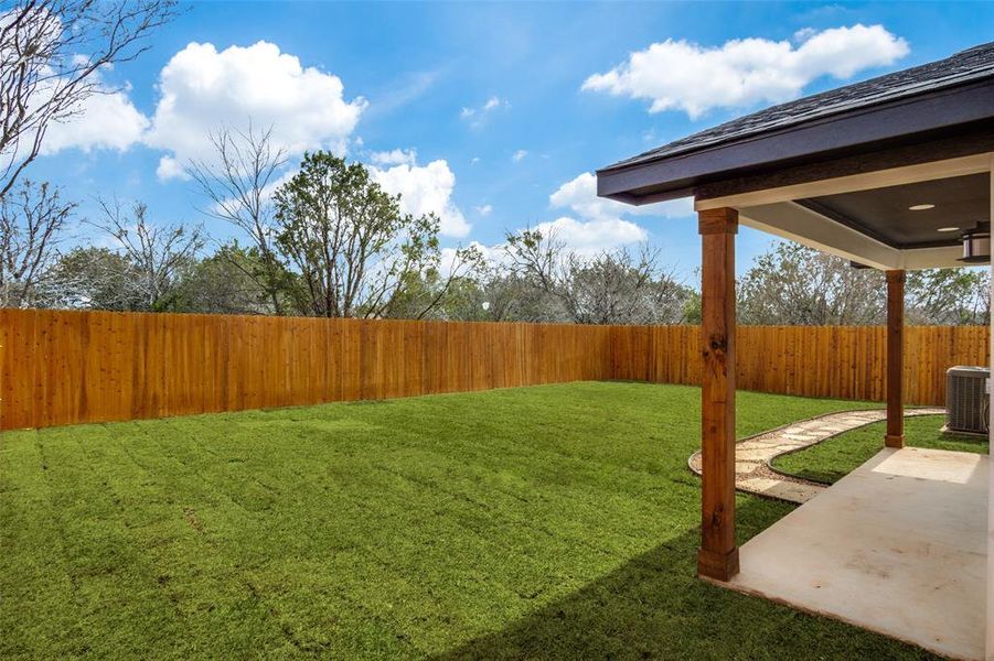 View of yard with a patio, central AC, and a fenced backyard