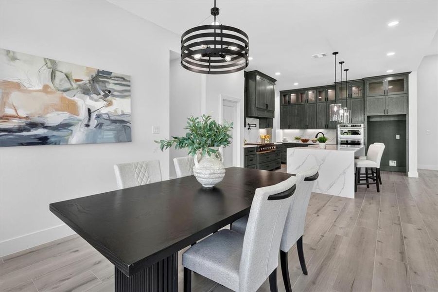 Dining area featuring a contemporary black dining table and light wood-finish flooring
