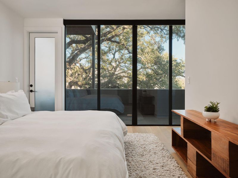Bedroom featuring access to outside and light wood-style flooring