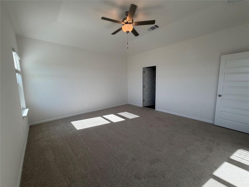 Unfurnished bedroom with carpet flooring and ceiling fan Unfurnished bedroom with carpet flooring and ceiling fan