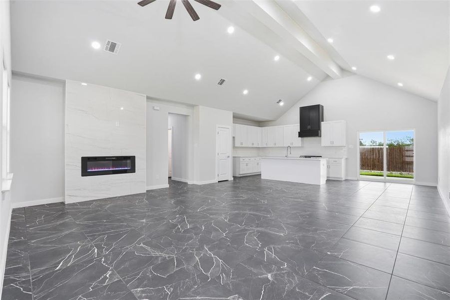 Spacious interior featuring vaulted ceilings and recessed lighting