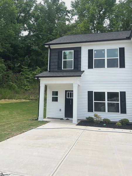 Front exterior of a new home in Parkstone Place Townhomes, Roebuck, SC, highlighting curb appeal (Image 1). Front exterior of a new home in Parkstone Place Townhomes, Roebuck, SC, highlighting curb appeal (Image 1).
