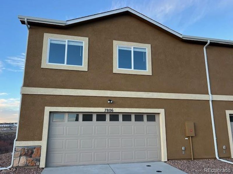 Front exterior of a new home in , Colorado Springs, CO, highlighting curb appeal (Image 1). Front exterior of a new home in , Colorado Springs, CO, highlighting curb appeal (Image 1).
