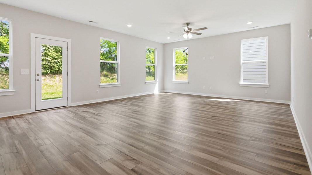 Gathering room with hard surface flooring and bright natural light through windows Gathering room with hard surface flooring and bright natural light through windows