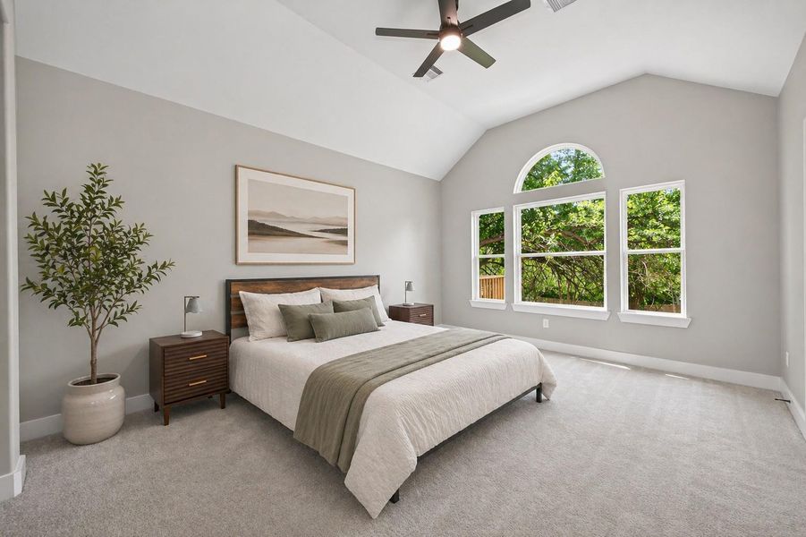 Spacious primary suite with plenty of natural light and room for a full bedroom set.