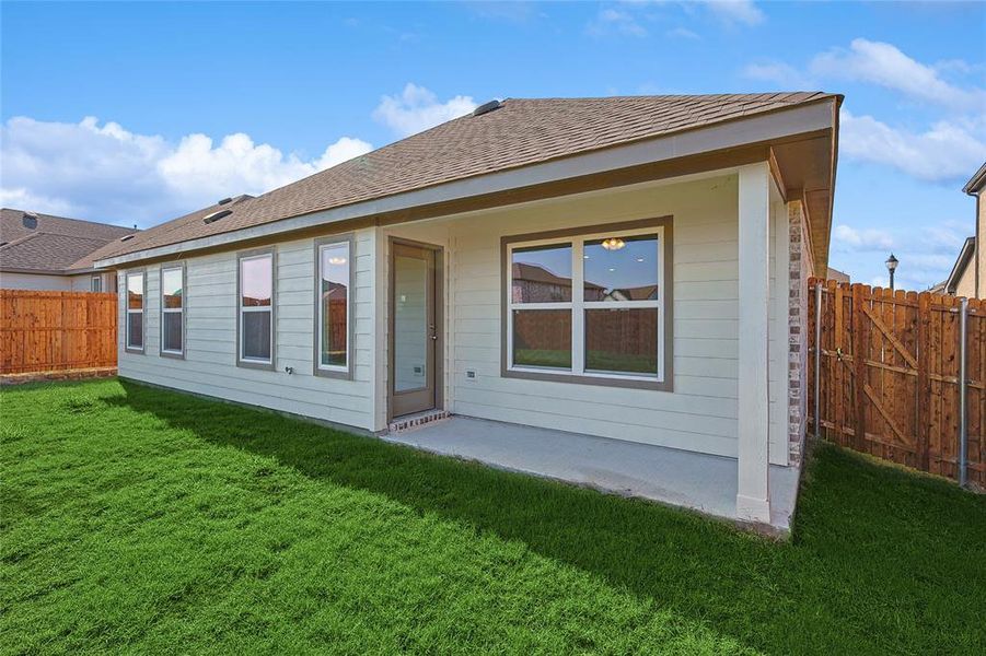 Rear view of property with a yard