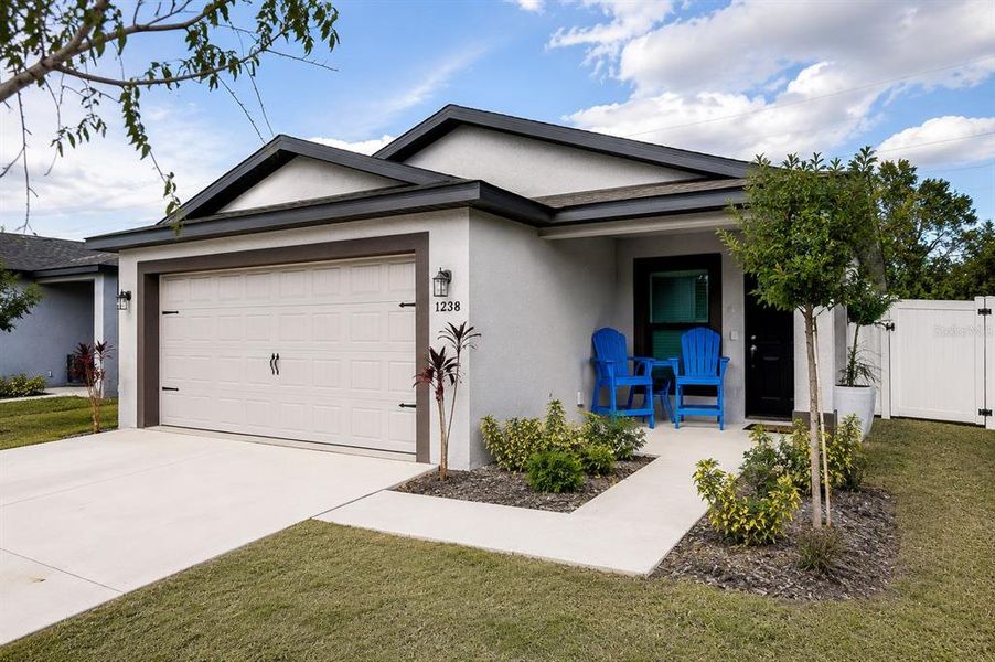 Front exterior of a new home in The Crossing at Palm River, Tampa, FL, highlighting curb appeal (Image 1). Front exterior of a new home in The Crossing at Palm River, Tampa, FL, highlighting curb appeal (Image 1).