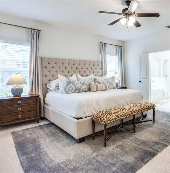 Bedroom with carpet flooring, ensuite bath, and ceiling fan