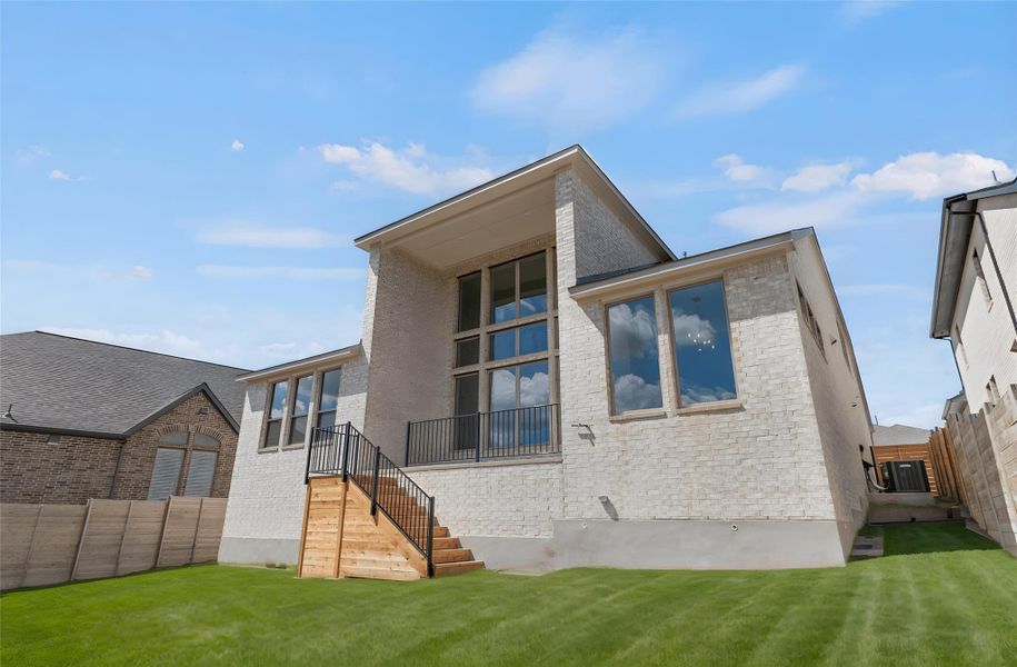 Rear view of property with a fenced backyard and brick siding Rear view of property with a fenced backyard and brick siding
