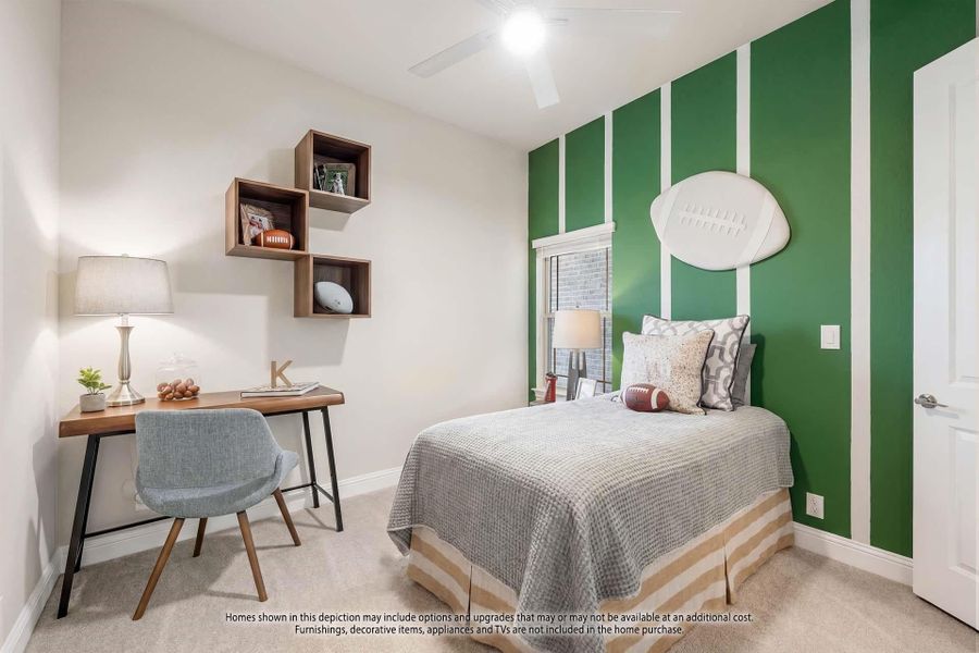Kids bedroom with football-themed green accent wall, twin bed, desk, and wall-mounted shelves Kids bedroom with football-themed green accent wall, twin bed, desk, and wall-mounted shelves