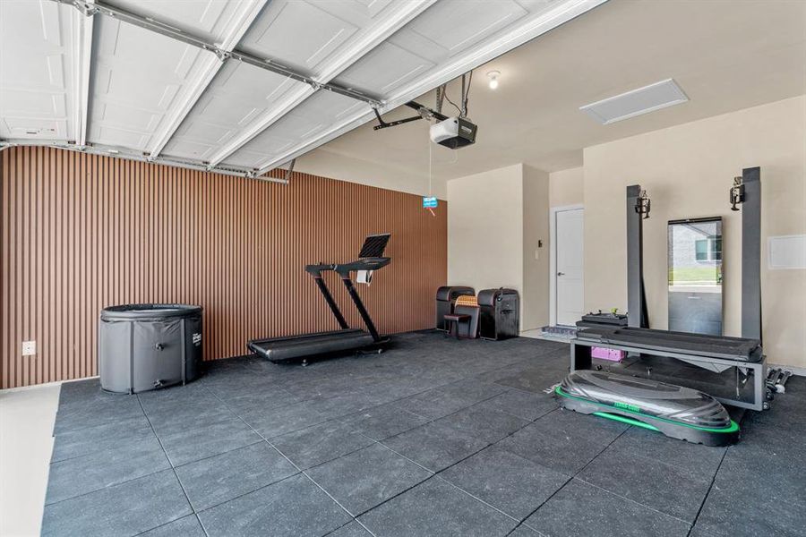 Garage with wood walls and a garage door opener Garage with wood walls and a garage door opener