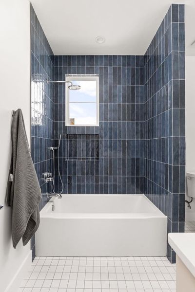 Full bathroom featuring vanity, light tile patterned floors, and shower / bath combination