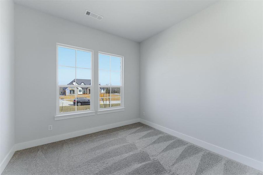 Empty room with light carpet and baseboards