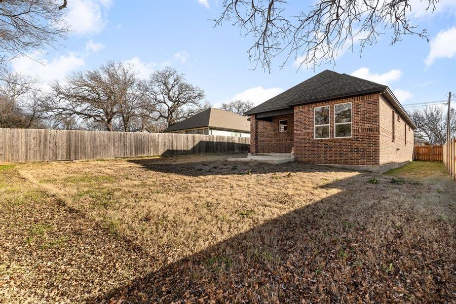 Back of house with a lawn