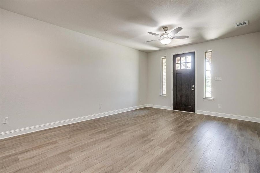 Foyer entrance featuring light wood-type flooring and ceiling fan