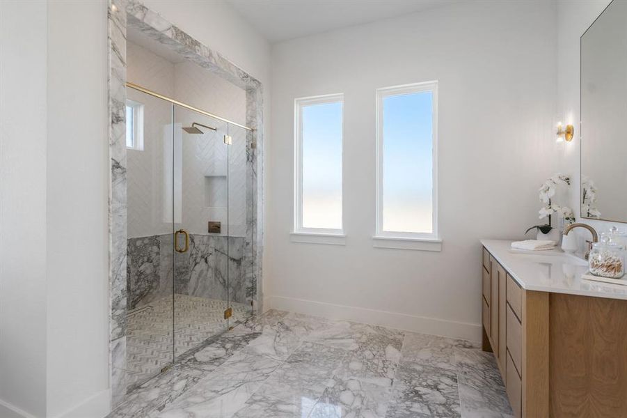 Bathroom with vanity and a shower with shower door