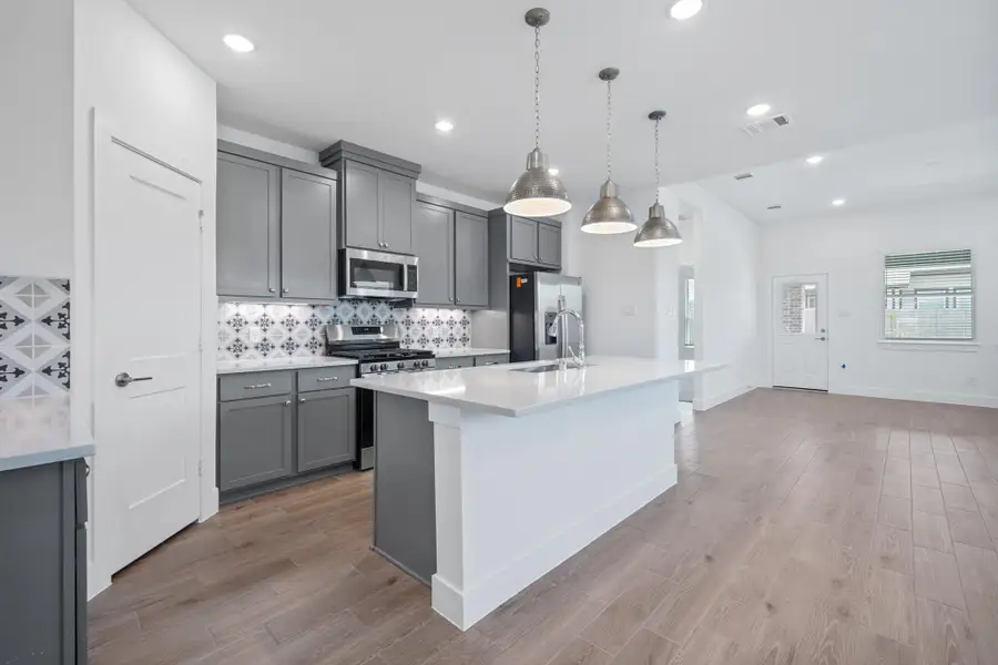 Representative furnished interior of a home built from the Sage by Chesmar Homes in Sunterra, Katy (Image 4).