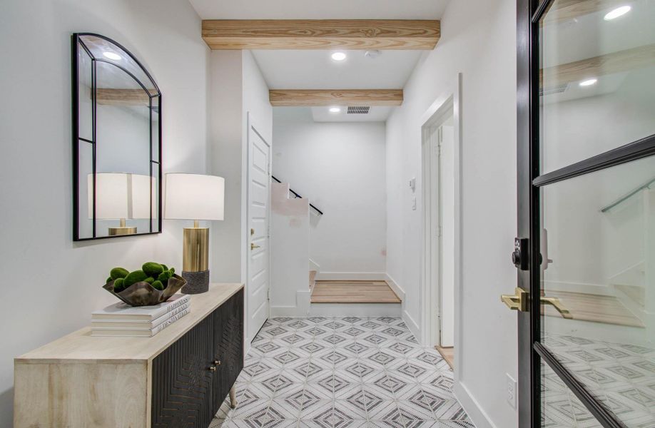 Gorgeous entry with a contemporary feeling with a touch of farmhouse highlighted by the natural wooden beams. First floor bedroom/ study/ office, generous size closet and full bath off the entry on the right.
