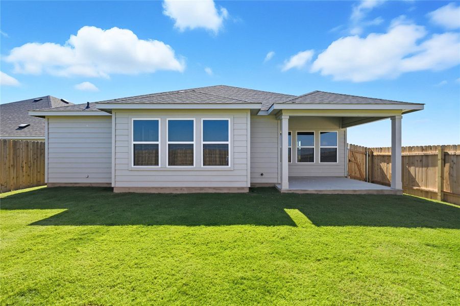 Rear view of house featuring a patio area, a fenced backyard, and roof with shingles Rear view of house featuring a patio area, a fenced backyard, and roof with shingles