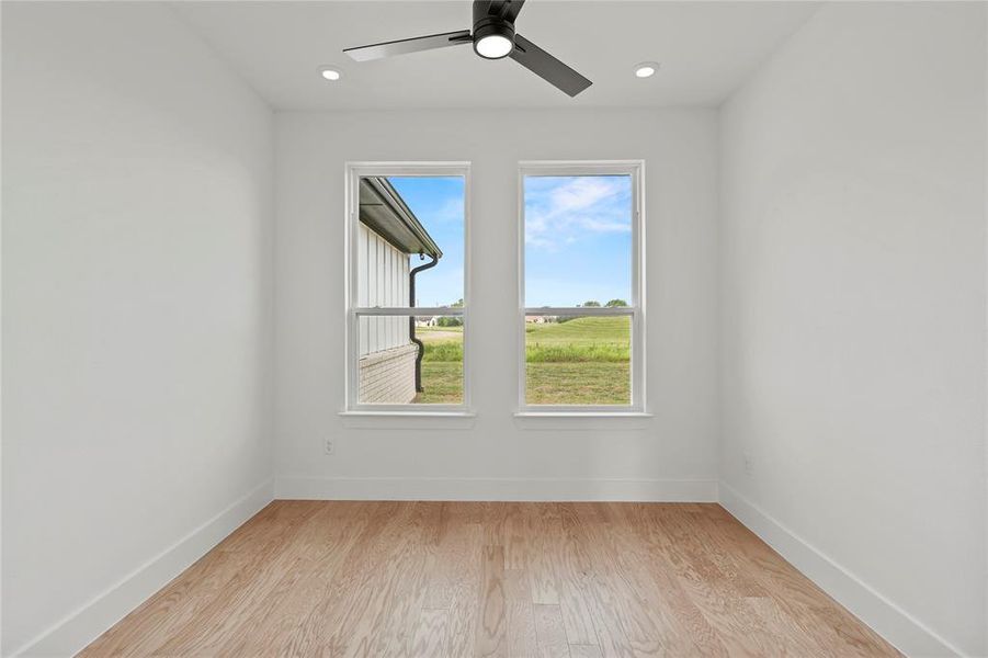 Empty room with light wood-style flooring, ceiling fan, and recessed lighting Empty room with light wood-style flooring, ceiling fan, and recessed lighting