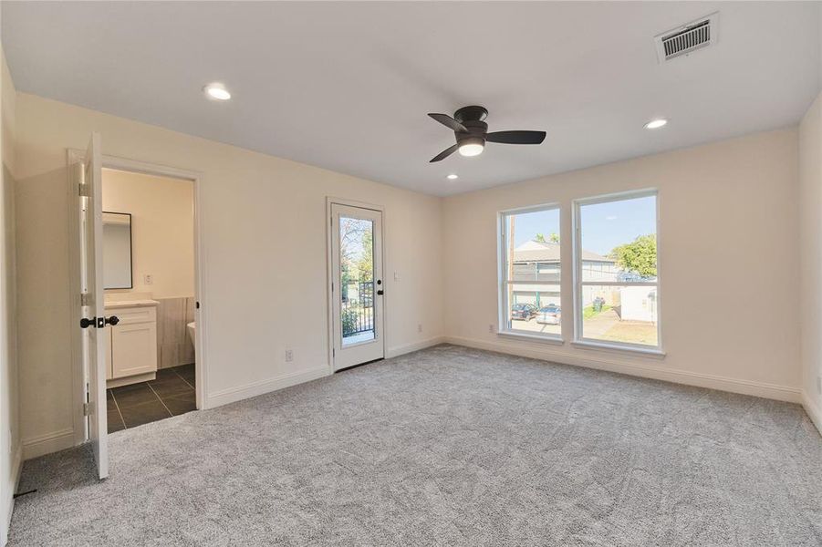 Carpeted empty room featuring ceiling fan