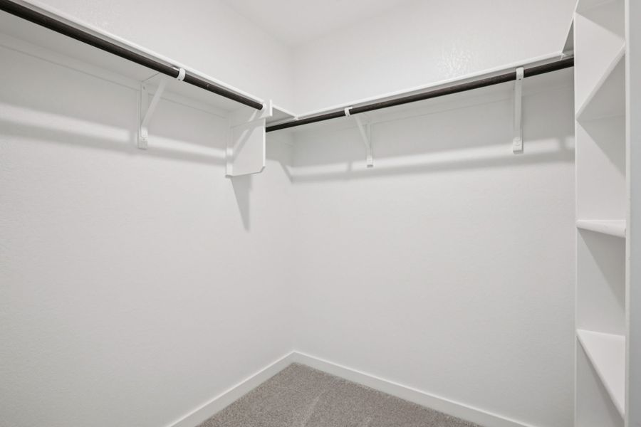 A white wall with a metal railing.