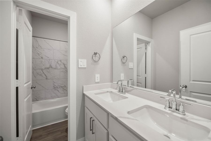Well-appointed baths with modern fixtures, quartz countertops, and stylish tile accents. Well-appointed baths with modern fixtures, quartz countertops, and stylish tile accents.