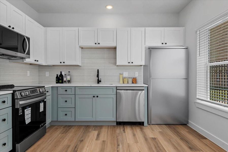 Kitchen features sleek quartz countertops, stainless steel appliances, and a modern layout designed for both style and functionality. Fridge included. Kitchen features sleek quartz countertops, stainless steel appliances, and a modern layout designed for both style and functionality. Fridge included.