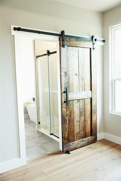 Wood-finish barn door with matte black hardware
