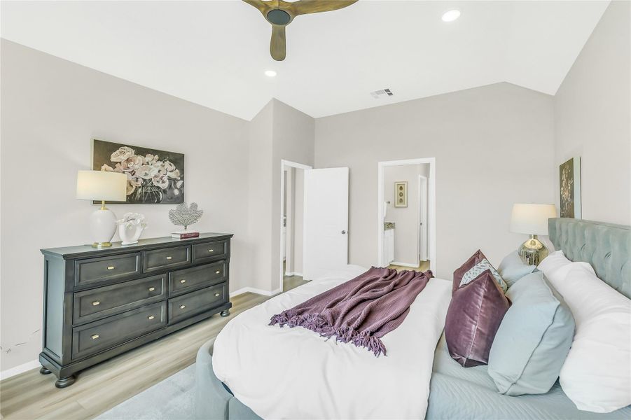 A sophisticated layout offers plenty of room for a full bedroom set and seating area, creating a private sanctuary within the home.