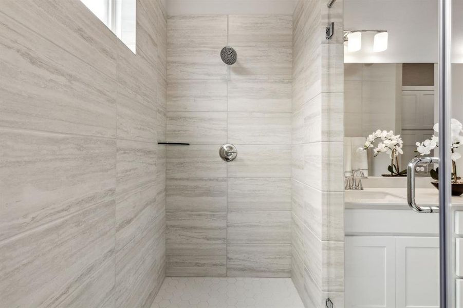 Bathroom featuring vanity and a tile shower