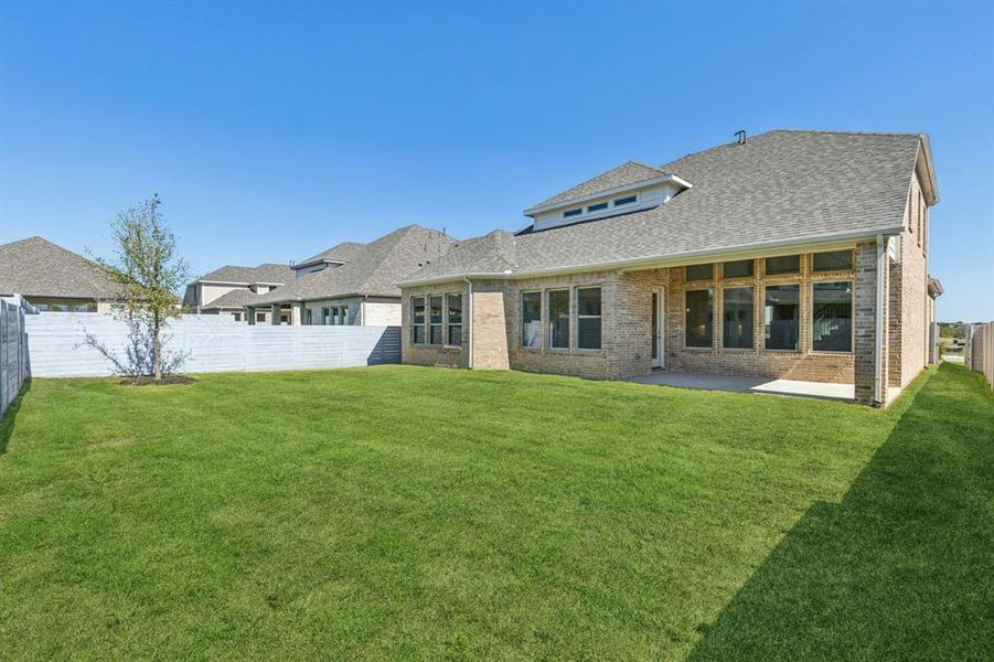 Back of house with a patio area and a yard