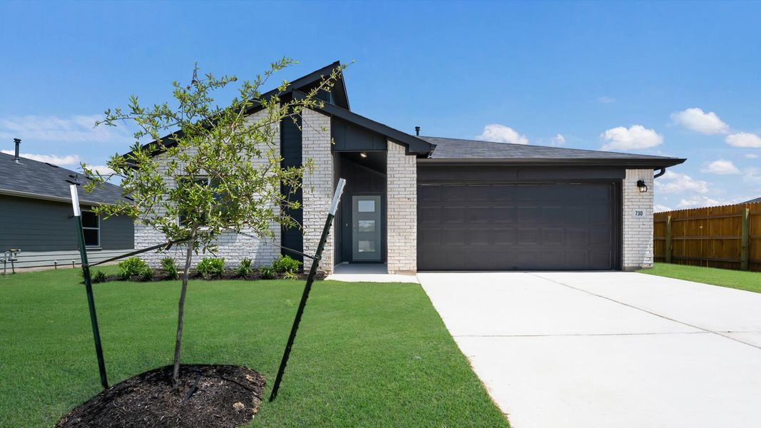 Front exterior of a new home in Southgrove, Kyle, TX, highlighting curb appeal (Image 2).