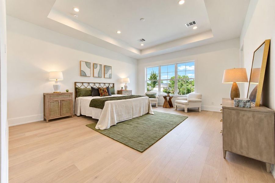 Spacious second-floor primary retreat featuring warm wood floors, recessed lighting, and abundant natural light. Generous proportions provide plenty of room for a sitting area, while the serene, sophisticated design creates a comfortable escape at the end of the day. Spacious second-floor primary retreat featuring warm wood floors, recessed lighting, and abundant natural light. Generous proportions provide plenty of room for a sitting area, while the serene, sophisticated design creates a comfortable escape at the end of the day.