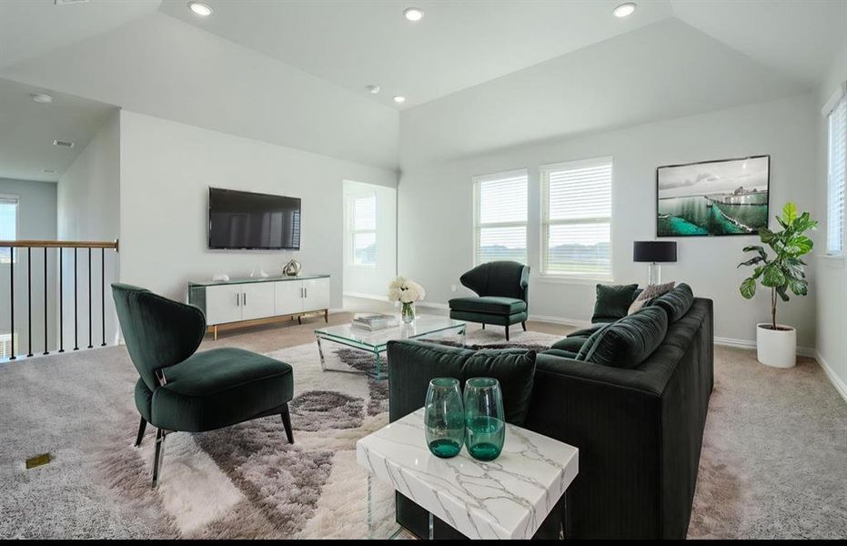 Living area with light carpet, vaulted ceiling, and recessed lighting Living area with light carpet, vaulted ceiling, and recessed lighting