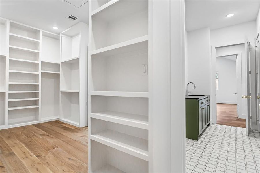 Entrance to laundry from primary bath via  primary closet