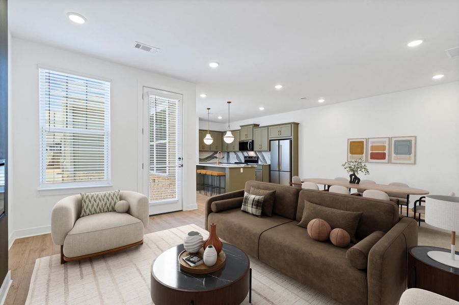 Open-concept living space featuring wood-finish flooring, recessed lighting, and a white color palette Open-concept living space featuring wood-finish flooring, recessed lighting, and a white color palette