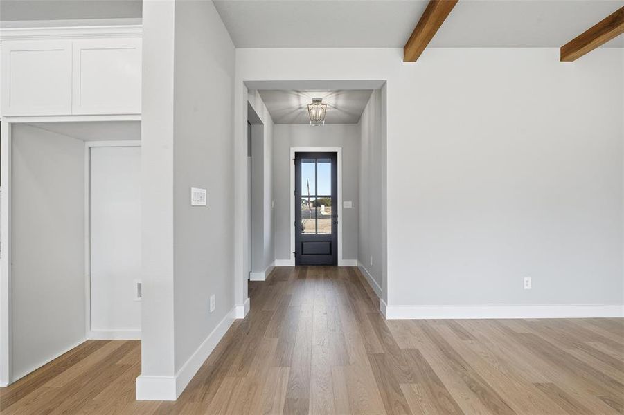 Foyer with light wood finished floors and beamed ceiling Foyer with light wood finished floors and beamed ceiling