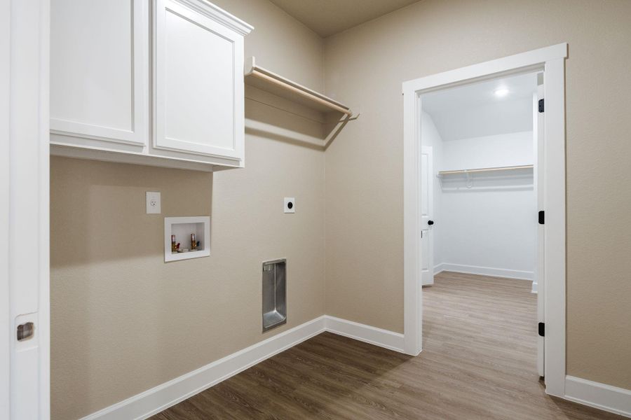 Laundry area with cabinet space, dark wood finished floors, hookup for a washing machine, and hookup for an electric dryer
