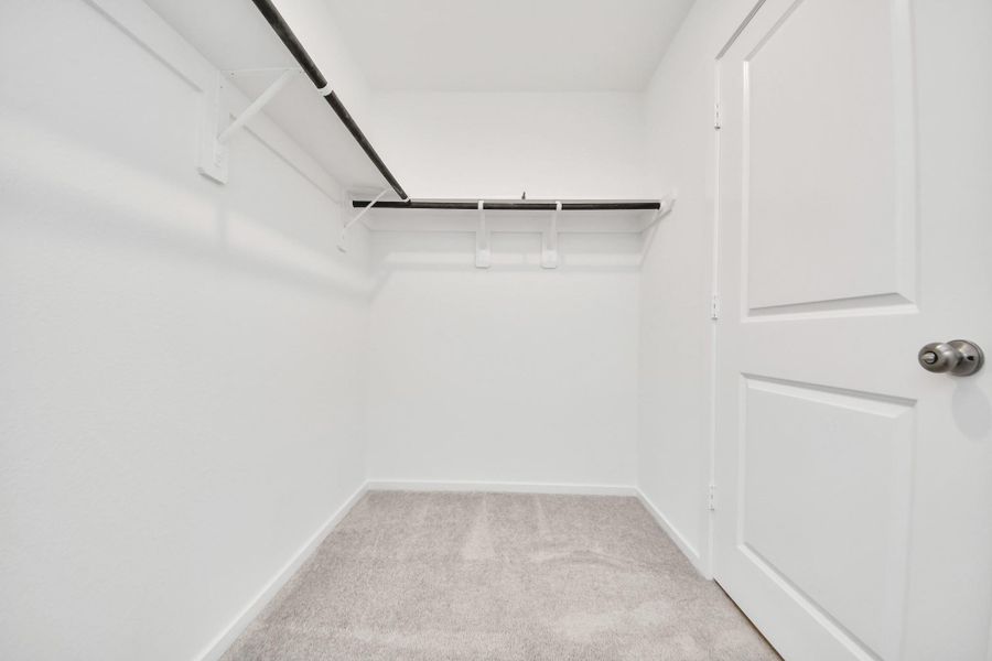 Large walk in closet with ample storage.
