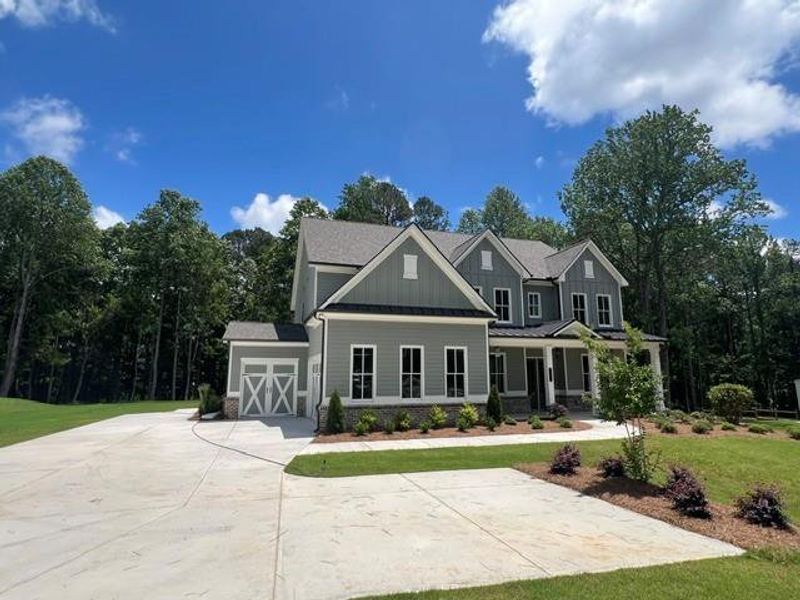 Front exterior of a new home in , Cumming, GA, highlighting curb appeal (Image 1). Front exterior of a new home in , Cumming, GA, highlighting curb appeal (Image 1).