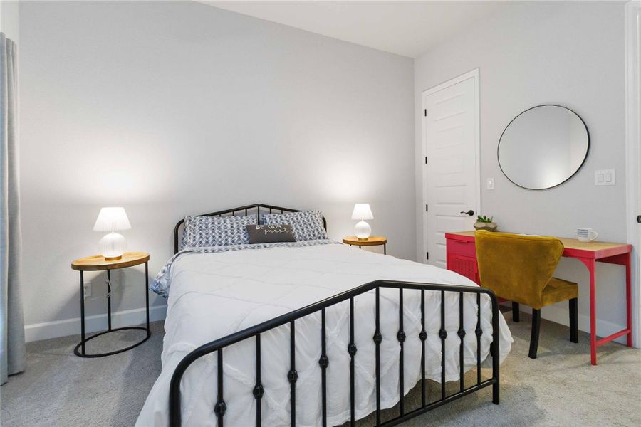 Bedroom featuring light carpet and baseboards Bedroom featuring light carpet and baseboards