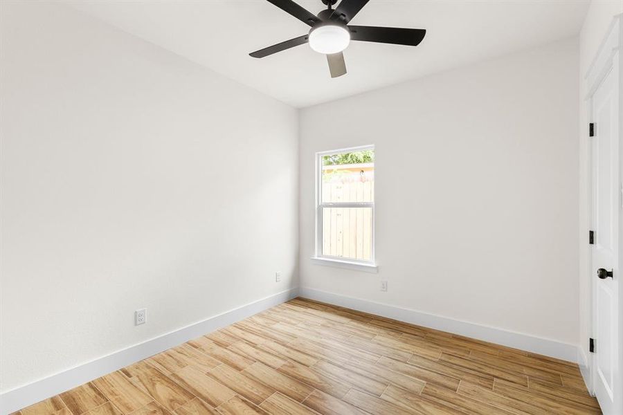 Unfurnished room featuring ceiling fan and light wood-type flooring