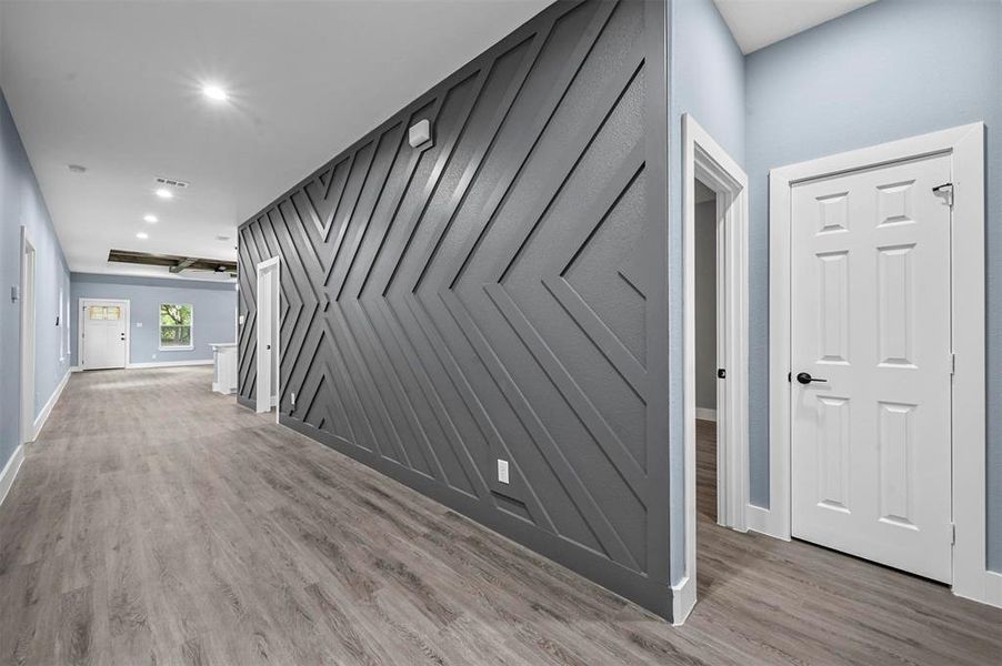 Hallway with hardwood / wood-style floors