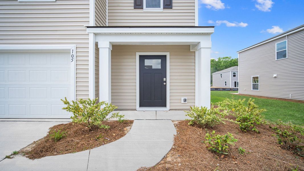 Front exterior of a new home in Cobblestone Village, Savannah, GA, highlighting curb appeal (Image 2). Front exterior of a new home in Cobblestone Village, Savannah, GA, highlighting curb appeal (Image 2).