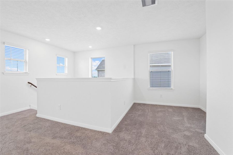 This intimate corner of the Game Room can be used as a seating or reading area. It is just outside the primary suite. This intimate corner of the Game Room can be used as a seating or reading area. It is just outside the primary suite.