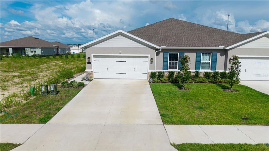 Front exterior of a new home in Park Ridge Villas, Spring Hill, FL, highlighting curb appeal (Image 23).
