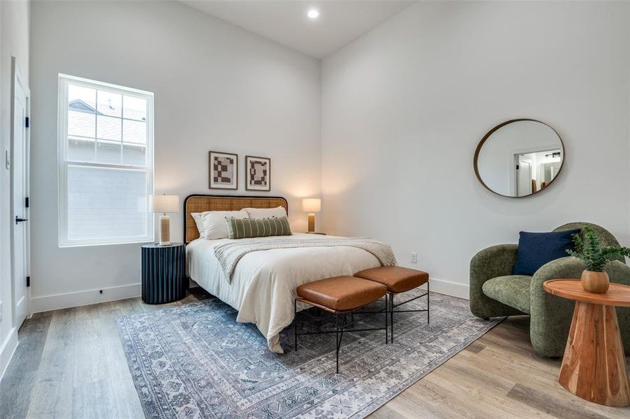 Bedroom with wood finished floors and recessed lighting